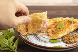 Fried homemade Khachapuri cake with cheese and meat, fried in pan with hand. Traditional Georgian