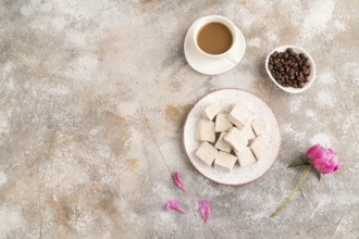 Coffee marshmallow with cup of coffee on brown concrete background. top view, flat lay, copy space