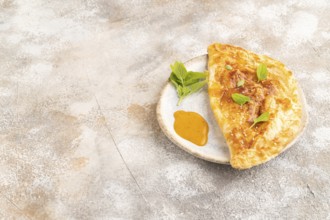 Fried homemade Khachapuri cake with cheese and meat, fried in pan. Traditional Georgian cuisine on