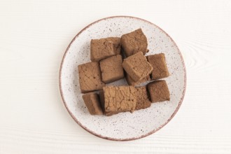 Chocolate marshmallow on white wooden background. top view, flat lay, close up