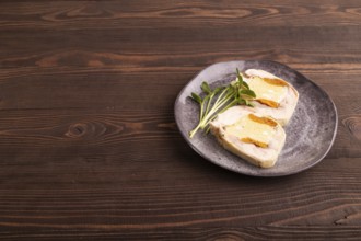 Chicken, egg and dried apricot meatloaf, microgreen on brown wooden. Diet, healthy eating. side