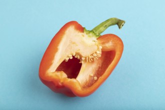 Red Cutted pepper on blue pastel background. Side view, copy space. Tropical, healthy food,