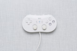 Top shot of a Wii Classic controller on a white Formica plate