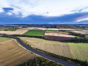 Sunset of Fields and Farms over Traprain Law and Hailes Castle from a drone, River Tyne,
