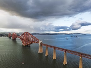 Rain clouds over Forth Bridge from a drone, Queensferry Crossing, Forth Estuary, Scotland, United