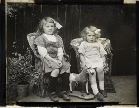 Monochrome magic lantern slide family portrait of two young girls presumably sisters circa 1900