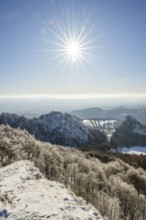 View over the hills and valleys from the mountain with hoarfrost on the branches in winter, Vápec,