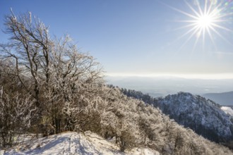 View over the hills and valleys from the mountain with hoarfrost on the branches in winter, Vápec,