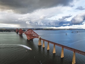 Rain clouds over Forth Bridge from a drone, Queensferry Crossing, Forth Estuary, Scotland, United