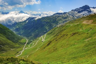 View to the left in the background at the lower cloud line Grimselpass, in front mountain pass