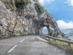 View from moving car on double rock arch rock gate Arches de Gréolières in on the Route de Gentelly