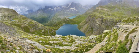 Panoramic view of left serpentine narrow bends from ascent pass road to Alpine pass Colle del Col