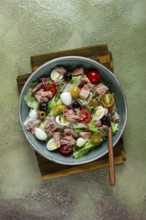 Salad with canned tuna, vegetable salad with quail eggs, lettuce, red onion, cherry tomatoes,