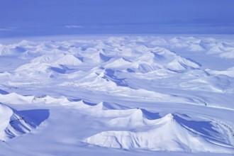 Aerial view over snow-covered mountains and valleys on Svalbard, Spitsbergen in spring, Norway
