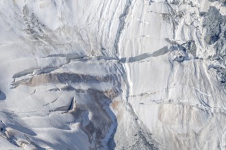 Intricate patterns of ice and rock are showcased in this stunning glacial landscape, revealing the