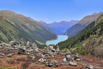 Hiking area below the Gepatsch Glacier in the Kaunertal with red rocks and the Kaunertal reservoir