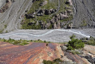 Hiking area below the Gepatsch Glacier in the Kaunertal with red rocks and the Faggenbach stream,