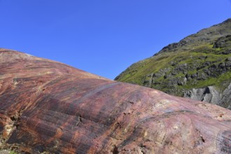 Hiking area below the Gepatsch Glacier in the Kaunertal with red rocks bearing traces of glacier