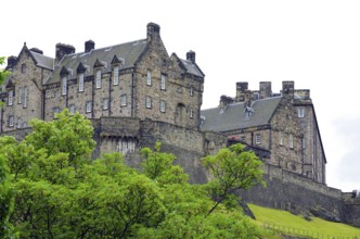 Old castle surrounded by green nature with overcast sky, Edinburgh Castle, Old Town, Edinburgh,