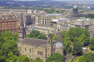View of a cityscape with impressive architecture and lots of greenery, view from Edinburgh Castle,