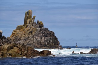 Coastal landscape with imposing cliffs and rough seas under a blue sky, Isles of Scilly, Cornwall,