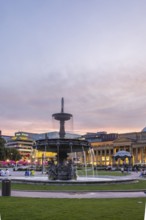 Evening atmosphere at Schlossplatz Stuttgart. View of Königstraße, art museum and Königsbau.