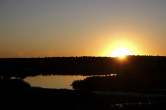 Landscape with lake, rising sun, August, Saxony, Germany