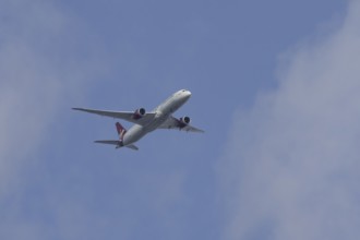 Boeing 787 Dreamliner jet passenger aircraft of Virgin Atlantic airlines in flight in a blue sky,