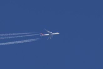 Boeing 747 jumbo jet cargo aircraft of Cargolux airlines with a vapour trail or contrail flying in