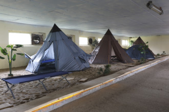 Indoor campsite in a former cattle shed at Fleether Mühle, Müritz National Park,