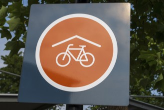 Covered bicycle parking space, sign with logo, Rheda-Wiedenbrück, Westphalia, North