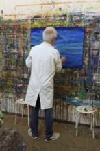 Painting a picture in the studio, Germany