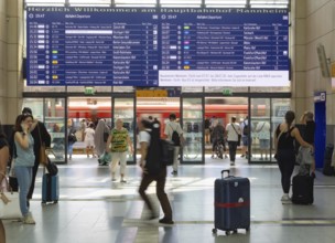 Mannheim main station, interior view with people and display board. Mannheim, Baden-Württemberg,