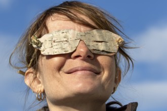 Woman wearing glasses made from birch bark, Gaspesie national park, Province of Quebec, Canada,