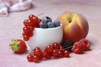 Various fruits in peel, redcurrant, peach, strawberry, blueberry, blackberry, raspberry