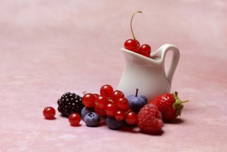 Various fruits with jug, redcurrant, raspberry, strawberry, blueberry, blackberry