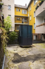 Heat pump in a backyard in Wuppertal, Germany, digitally reworked