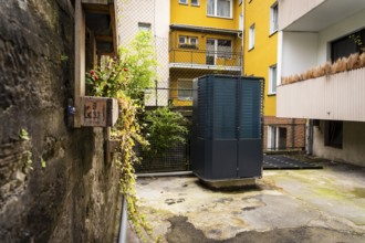 Heat pump in a backyard in Wuppertal, Germany, digitally reworked