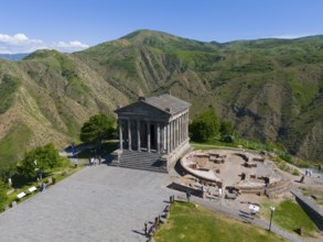 Ancient temple in a green mountain landscape with ruins and clear sky, aerial view, Temple of