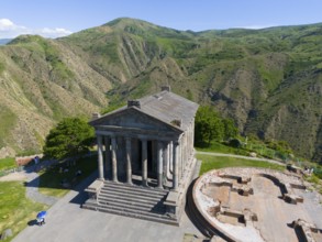 Ancient temple on a hill overlooking a green mountain landscape, aerial view, Temple of Garni,