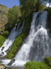 Natural waterfall under a blue sky with lots of greenery, aerial view, Shaki waterfall, Shaki,