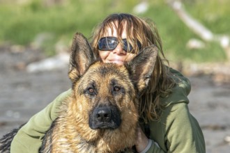 Woman hugging her German Shepherd, Gaspesie Region, Province of Quebec, Canada, North America