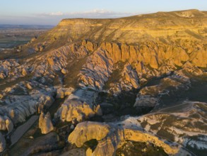 Breathtaking rock formations in the evening light in a vast landscape, aerial view, Göreme National