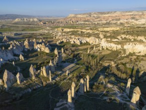 Aerial view of a rocky landscape in Cappadocia with striking rock formations and valleys under a