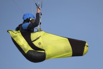 A paraglider or paraglider in front of a blue sky, near Hvide Sande, North Sea, Denmark