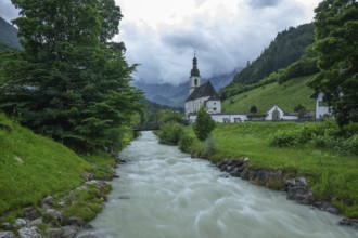 St Sebastian in Ramsau in Berchtesgadener Land with rain clouds after heavy rain