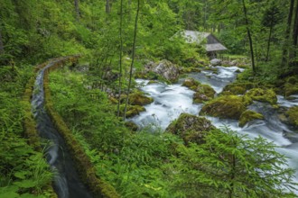Golling watermill from above at the waterfall with the water pipe. Traditional mill in an alpine