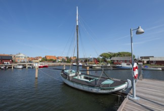 Old sailing boat in the harbour at a jetty, Ringkøbing, Ringkøbing Fjord, Denmark