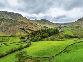 Farms and Mountains over road A591 from a drone, Grasmere Lake, Grasmere, Ambleside, Lake District,