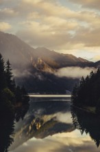 Sunrise with reflections and alpenglow in Lake Heiterwanger See in Tyrol in the Alps in Austria